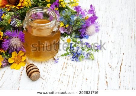 stock-photo-honey-and-wild-flowers-on-a-wooden-background-292821716.jpg