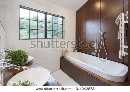 stock-photo-luxurious-modern-bathroom-with-dark-wood-and-bath-tub-and-round-double-washbasin-311.jpg