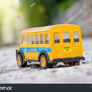 stock-photo-a-student-bus-toy-on-a-sidewalk-in-the-garden-1824569657.jpg